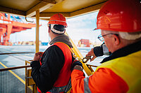 Ein Bauarbeiter sichert seinen Kollegen auf einer Bremer Baustelle. 