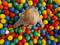 Ein Kind spielt in einem Bällebad