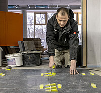 Ein Fliesenleger arbeitet an einem Projekt.