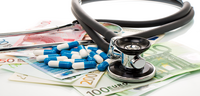 Ein Stethoskop, Tabletten und Geldscheine